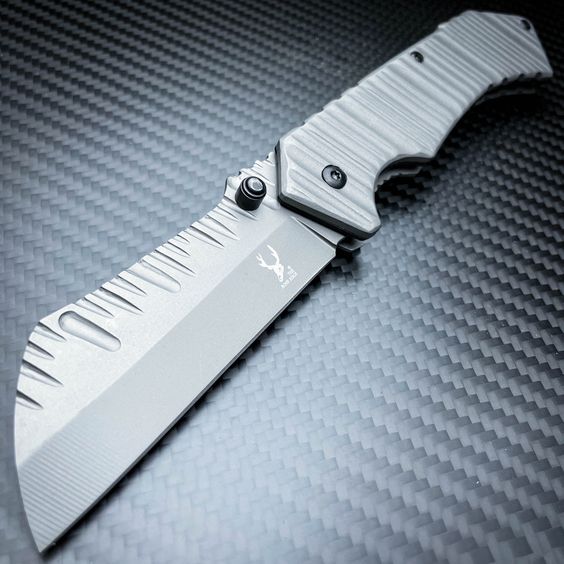 A custom cleaver pocket knife with blade scallops and scalloped scales on carbon fiber sheet.