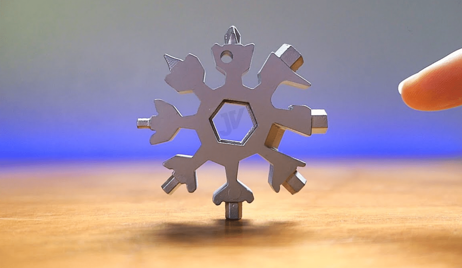 A snowflake multi-tool standing on one end on a countertop