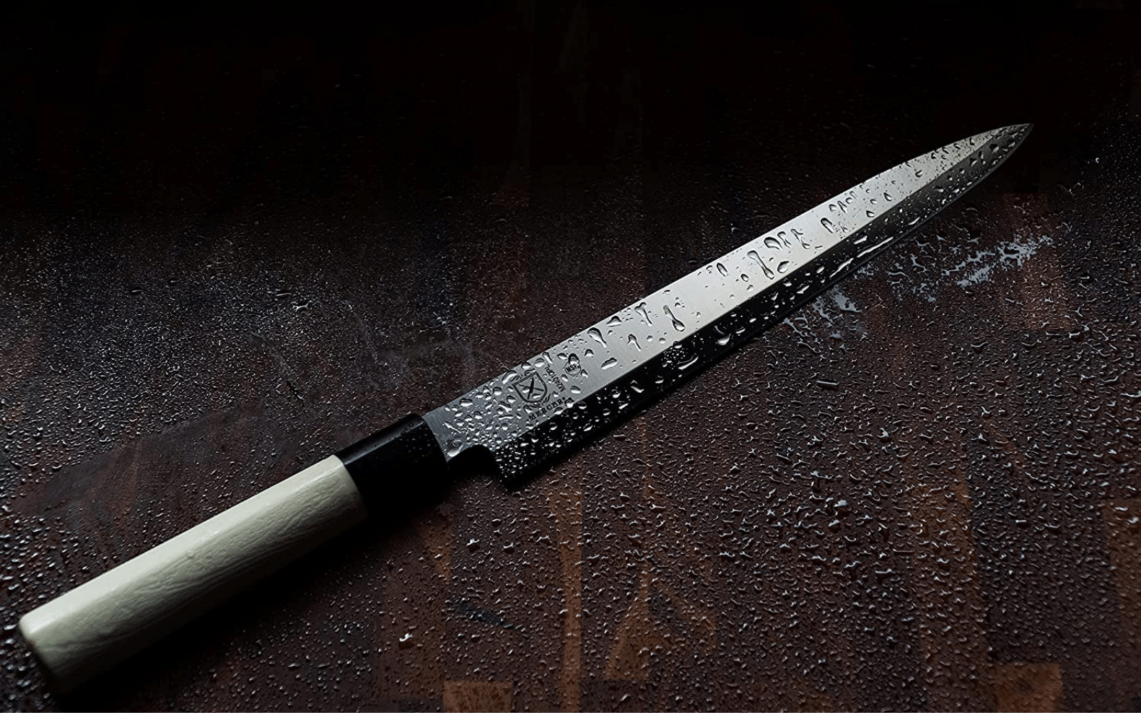 A wet Sashimi knife on a wet countertop 