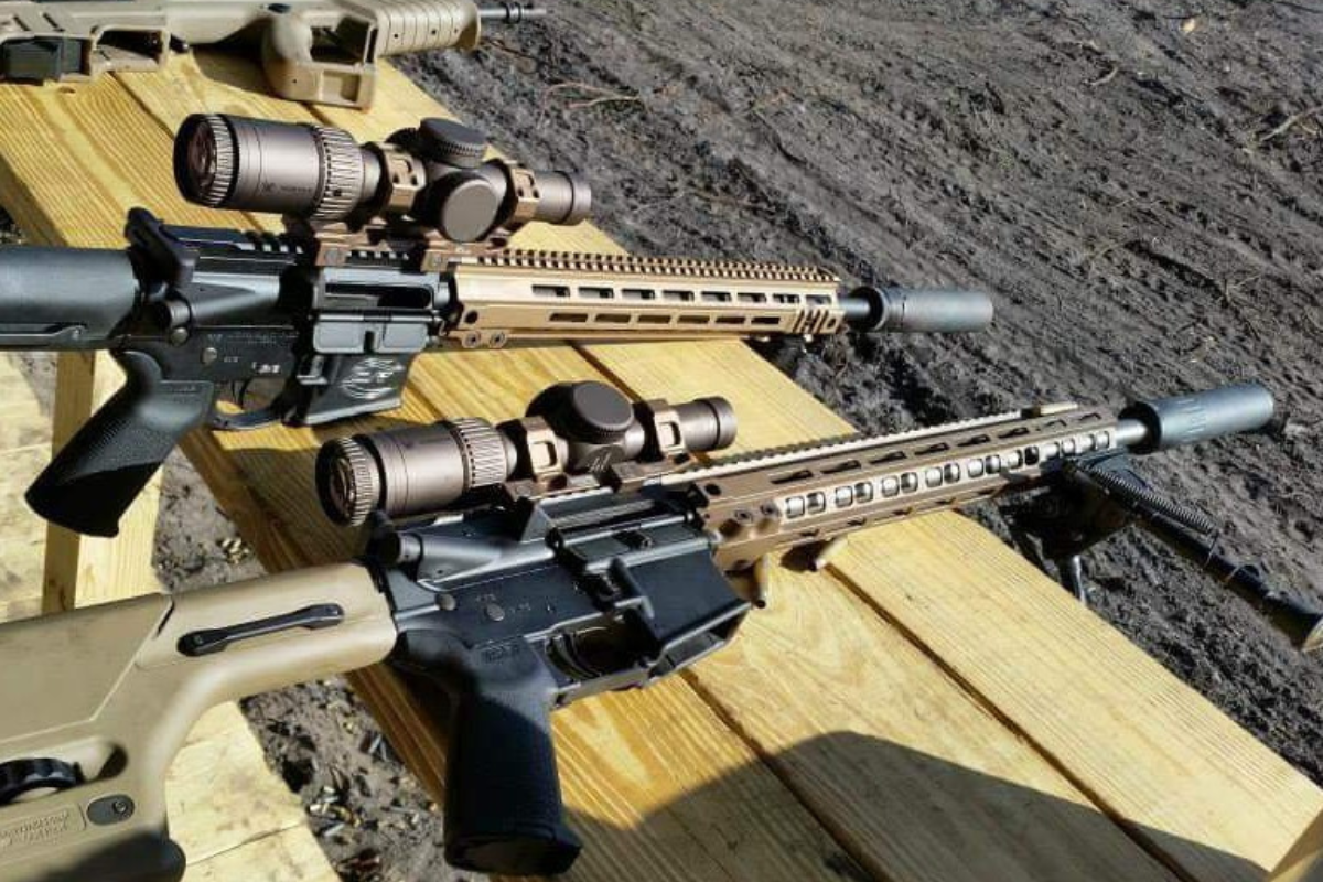 2 unloaded AR15s with suppressors, bipods and Geissele mounts for the optics