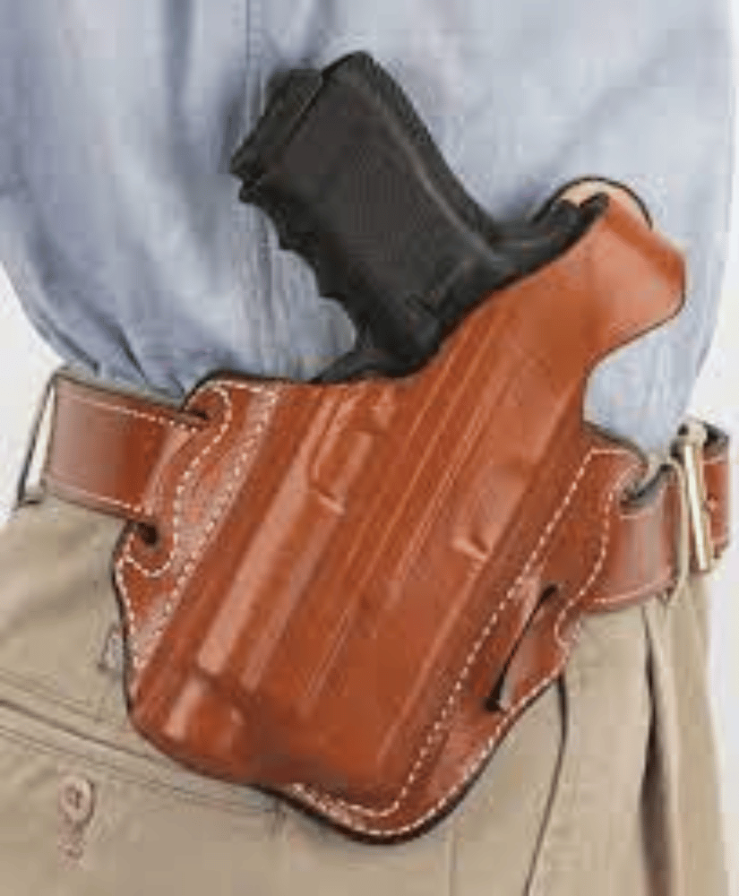 A brown leather OWB Glock 17 Holster, a man is wearing it and has his Glock 17 inserted.