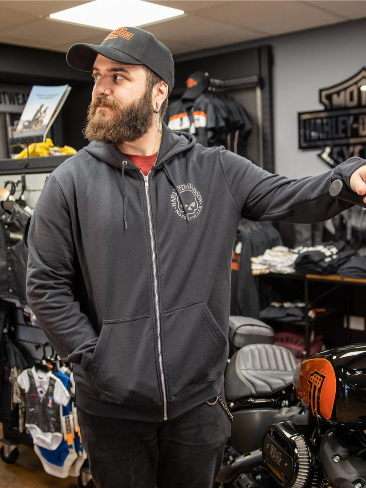 A man in a motorcycle shop wearing a Harley Davidson Hoodie