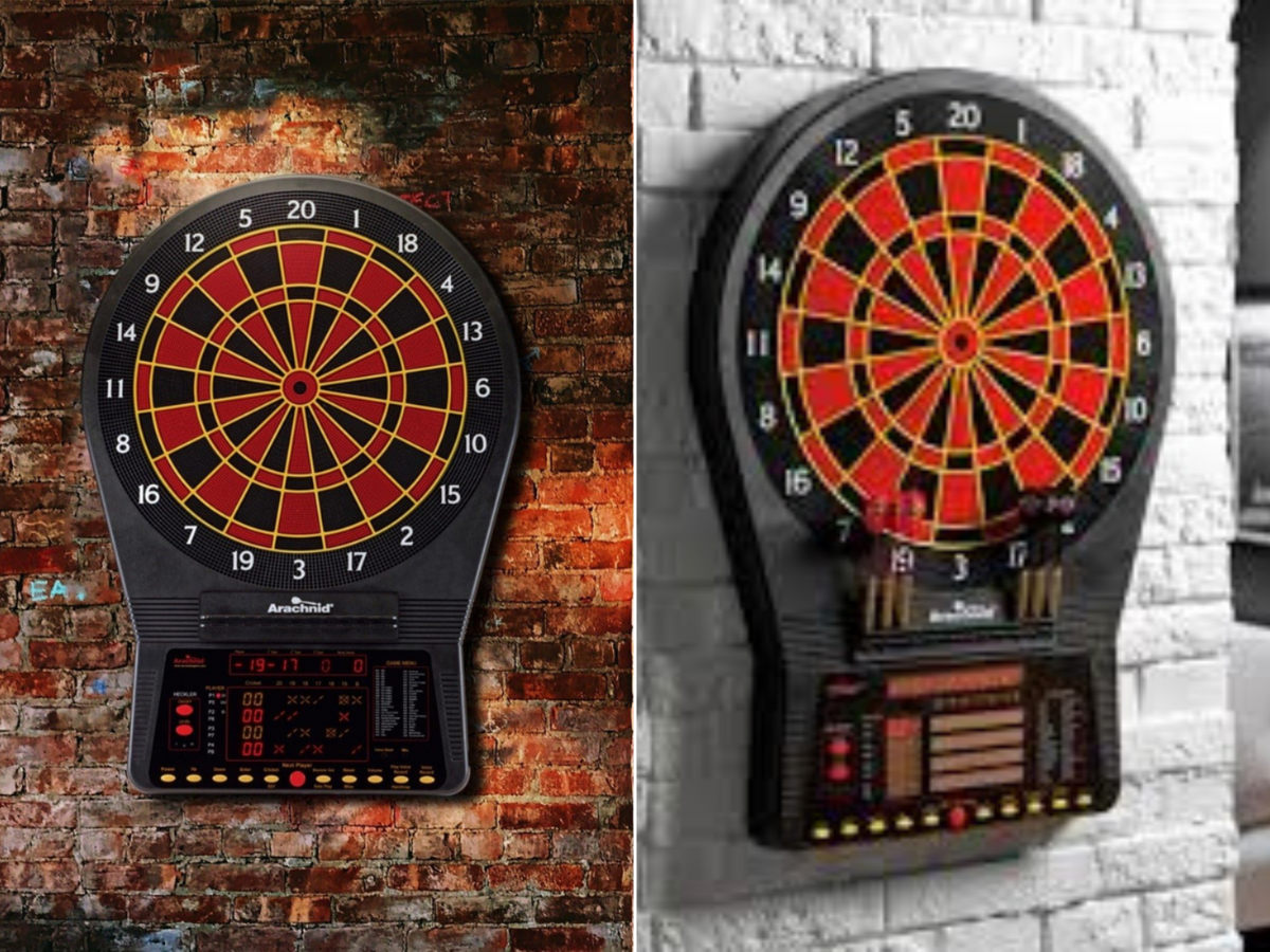 An Arachnid electronic dart board on a red brick wall and another one on a white brick wall.