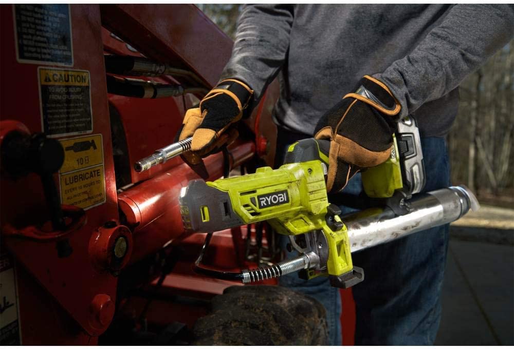 A man greasing a piece of heavy equipment.