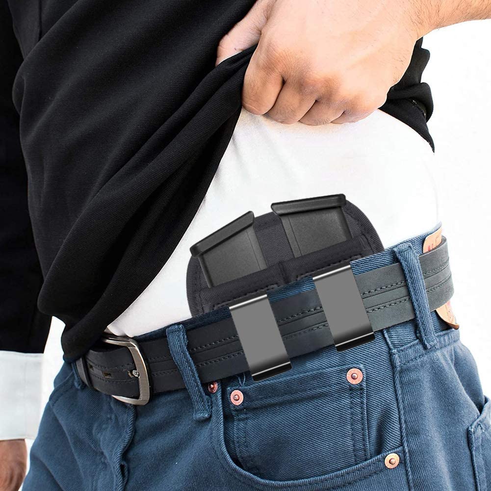 A man wearing a IWB 1911 magazine pouch carrying 2 extra magazines.