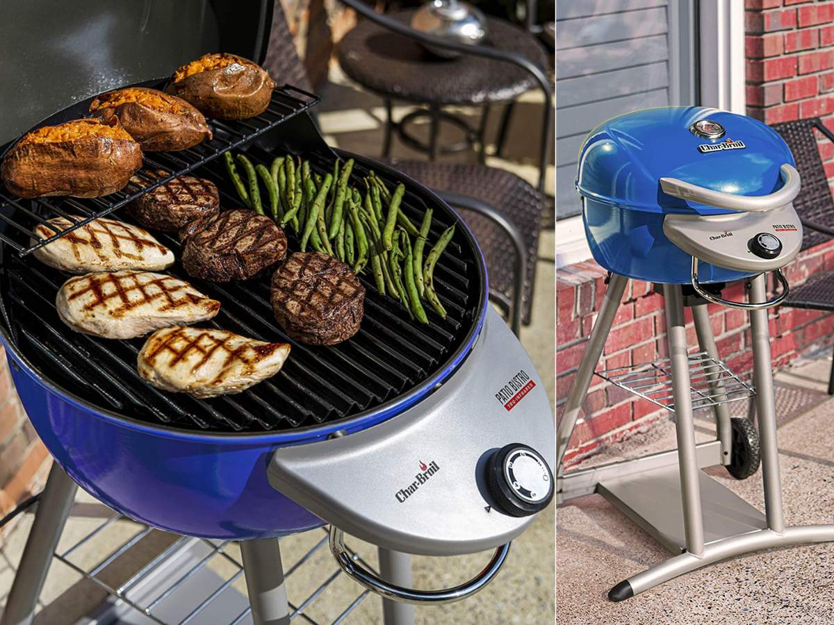 A grill with chicken, steak, and asparagus on an electric charcoal grill.