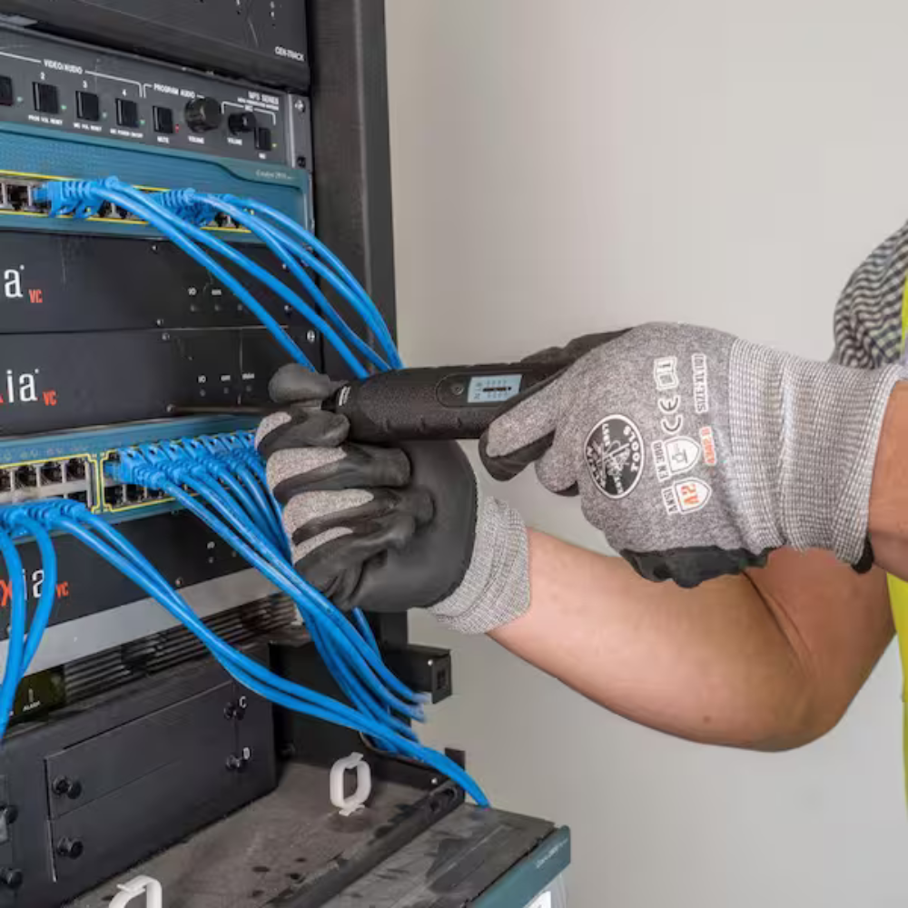 A man using an electric torque screwdriver on a computer case.