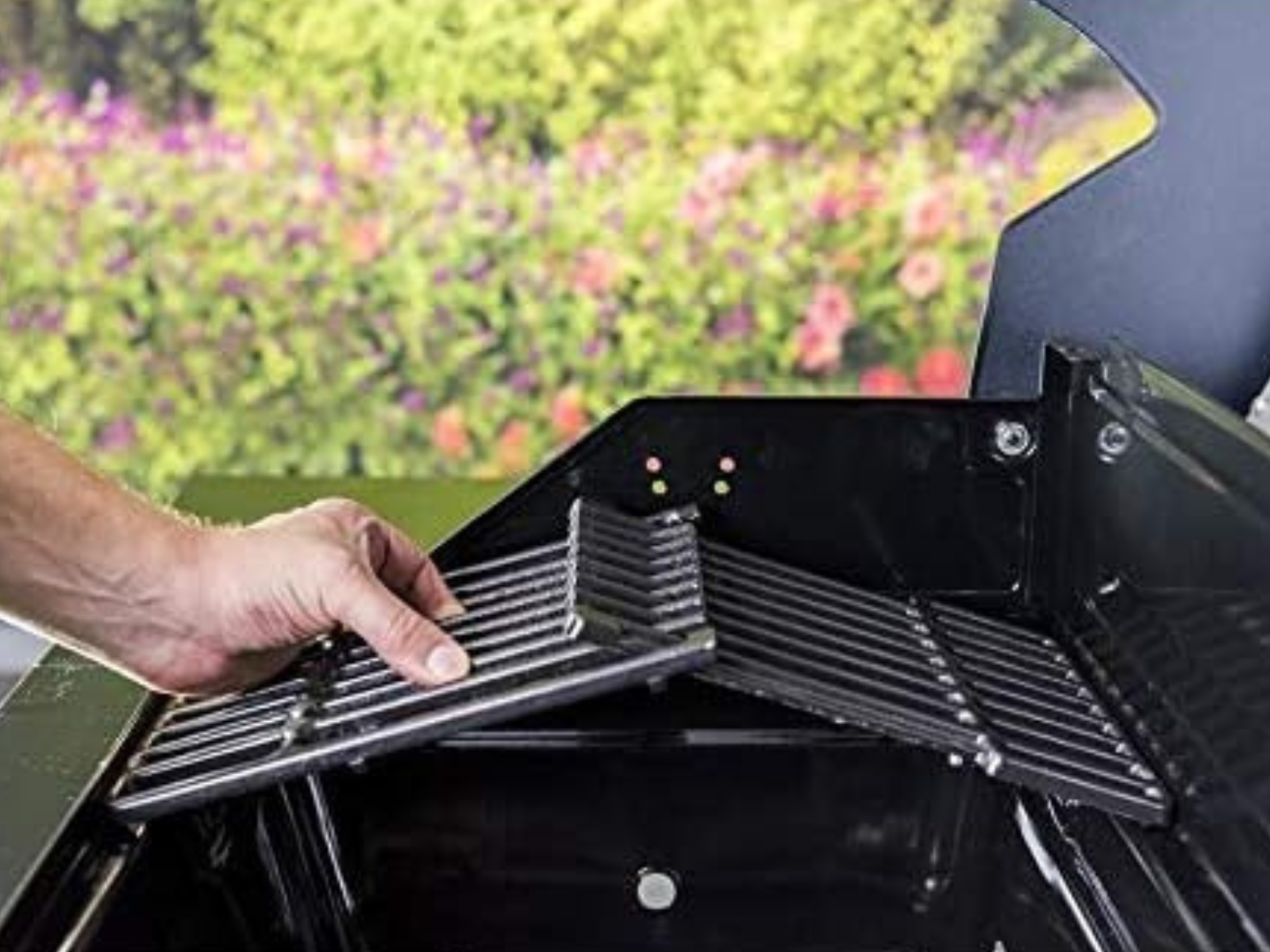 A man replacing grill grates on a grill