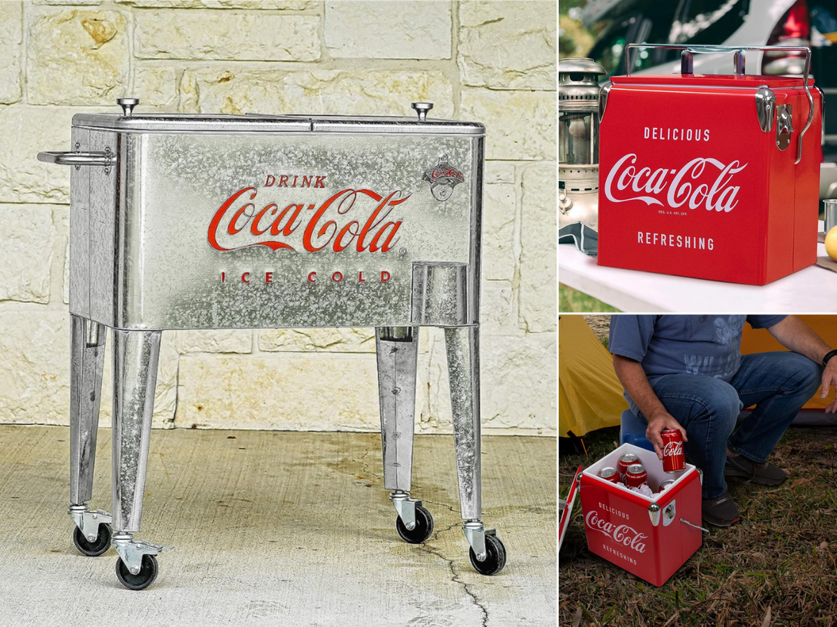 A galvanized Coke ice chest sitting by a block wall, a small cooler with a lantern, and a man getting a Coke from cooler.