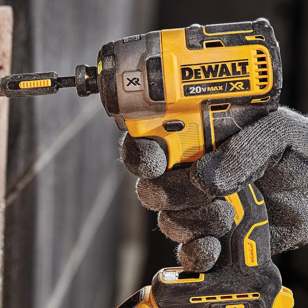 A man using a DeWalt Impact to run in a screw while wearing gloves.