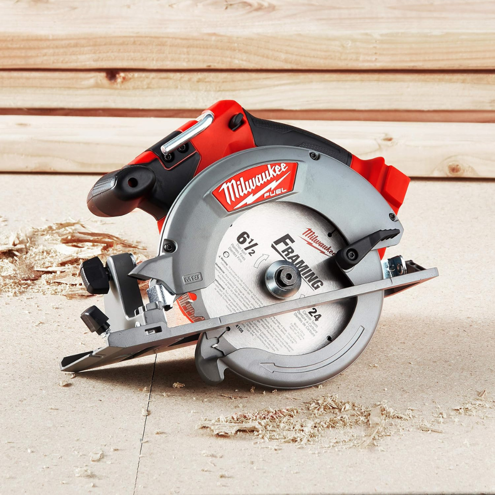 A Milwaukee Fuel circular saw sitting on a floor with sawdust scattered around the cordless circular saw.