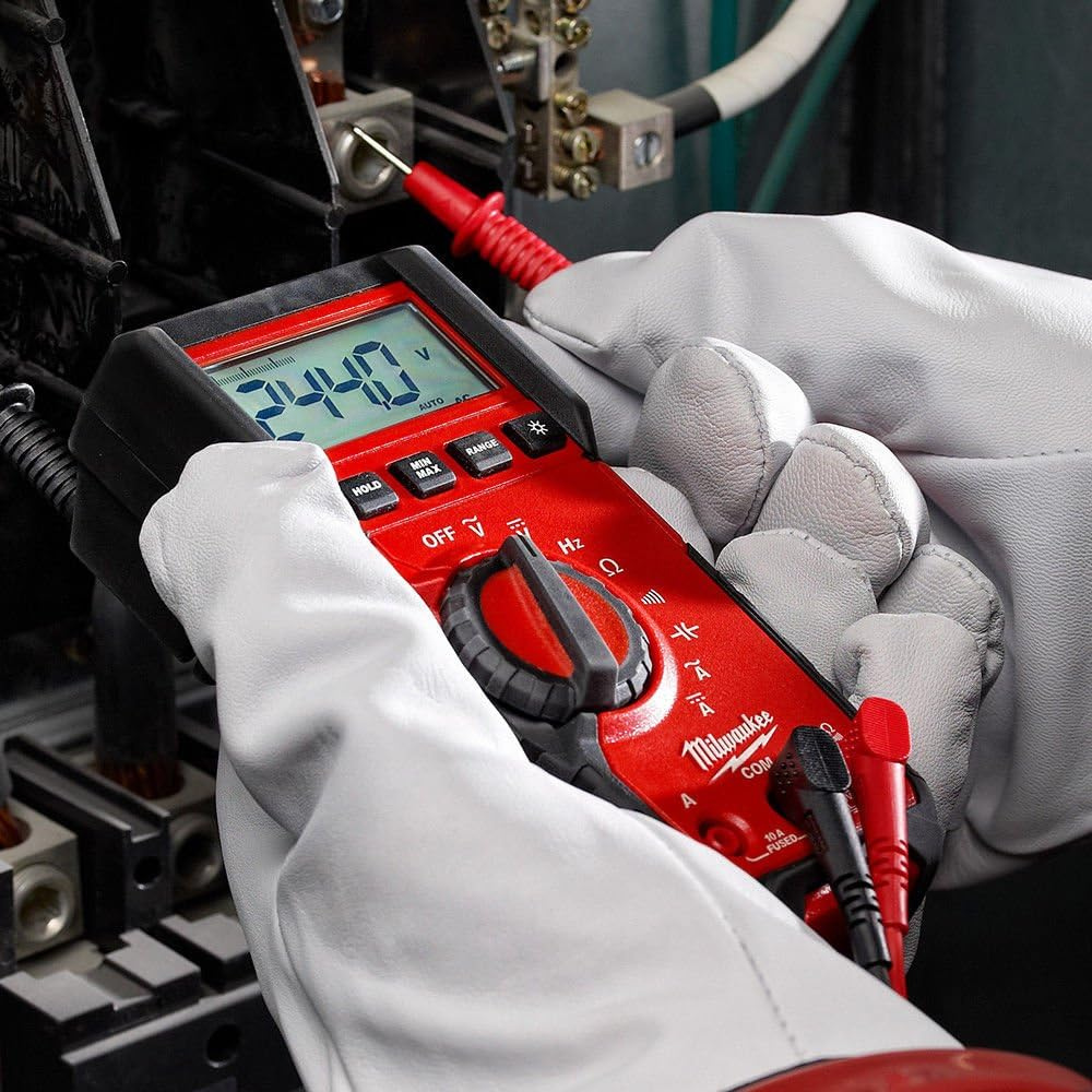 A man wearing white gloves checking an electrical panel with his digital multimeter from Milwaukee Tools