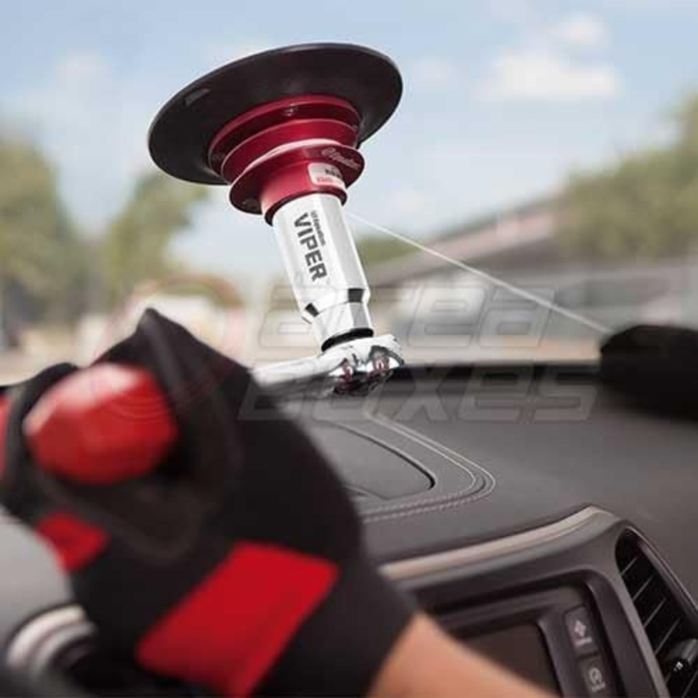 A man cutting a windshield out with a wire removal tool.