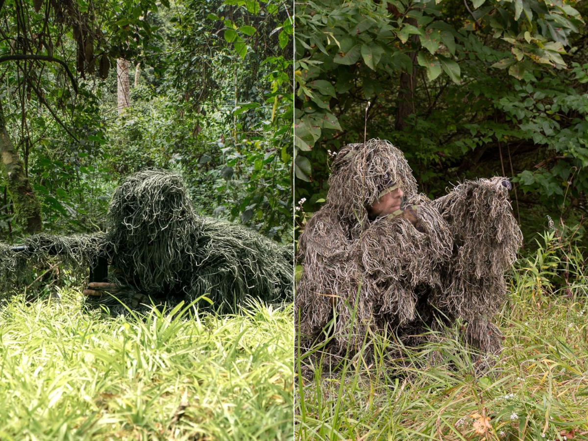 A sniper, prone, in a ghillie suit, and a man kneeling in a ghillie suit.