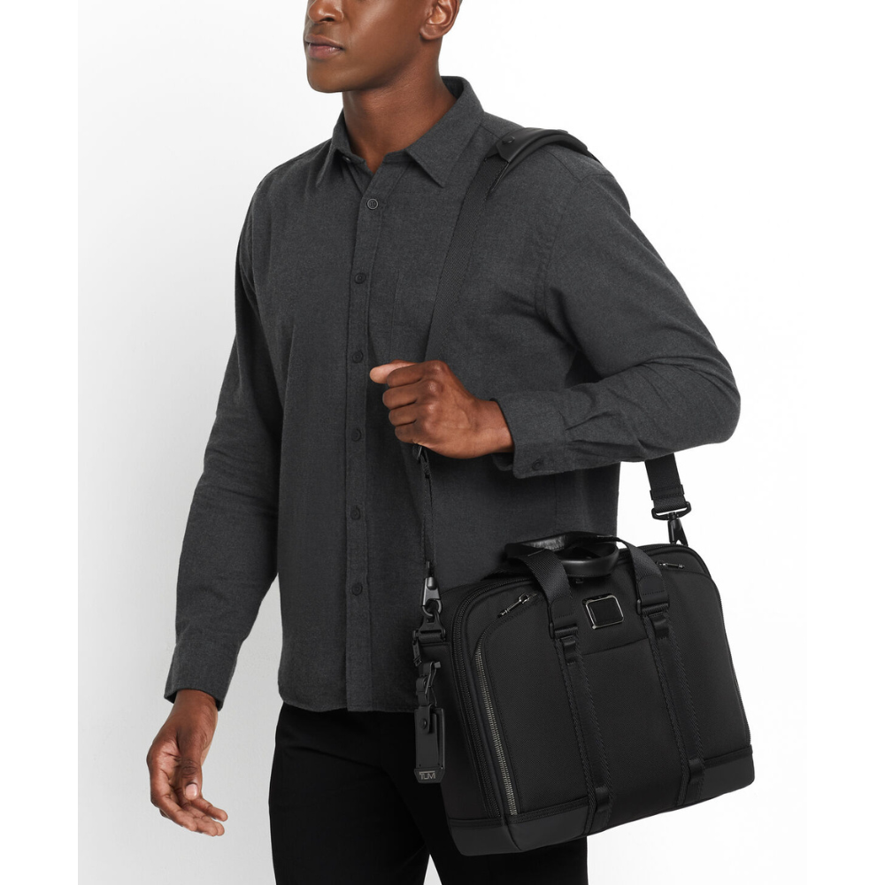 A man with a briefcase strapped over his shoulder.