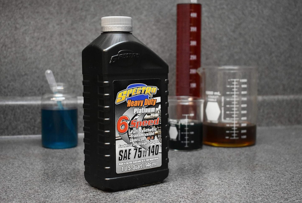 A quart of 6 speed oil in a lab with beakers of liquids in the background.