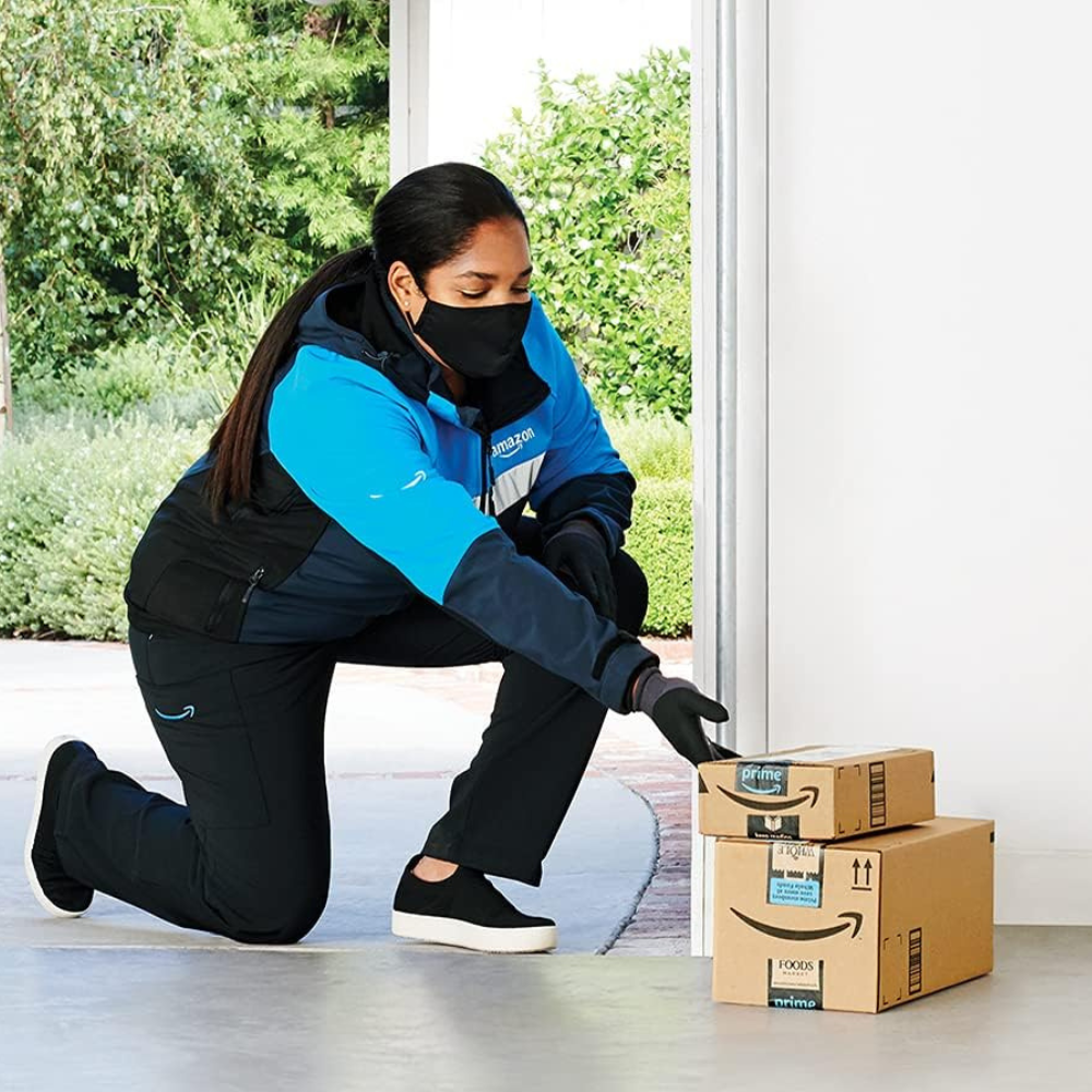 A courier delivering 2 Amazon cameras inside with the myQ home security.