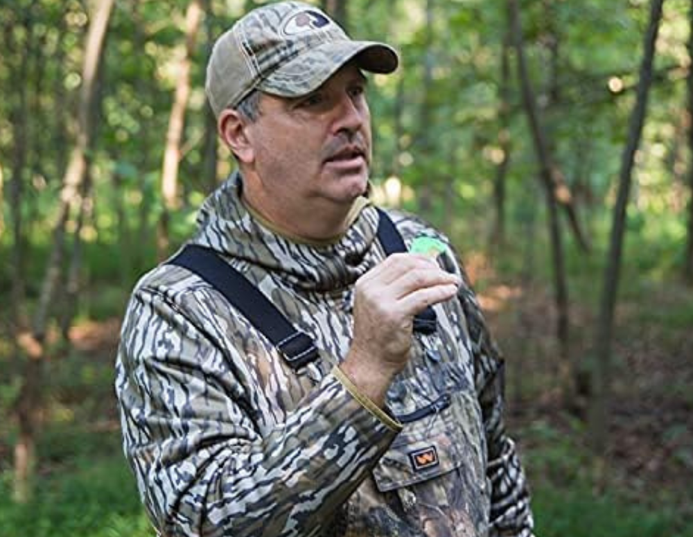 A man hunting using a mouth call to attract coyotes