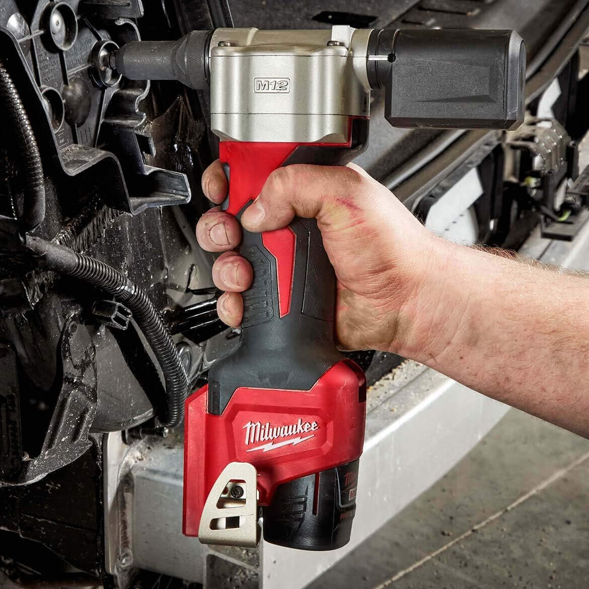 A M12 rivet gun being used to repair a car.