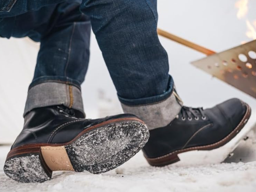 A man wearing cap toe Wolverine boots in the snow